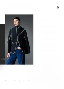 Detail of premium black wool cape with white contrast hand-stitched embroidery edges