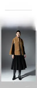 Detail of camel wool poncho showing white contrast stitching and thick premium fabric texture