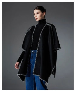 Detail of black double-faced wool shawl featuring white contrast stitching on edges