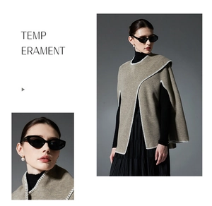 Close-up of khaki knit poncho featuring white hand-stitched decorative lockstitch edges