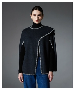 Detailed close-up of charcoal gray wool poncho featuring white contrast blanket stitch edges