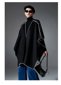 Chic black knitted shawl with contrast white blanket stitch trim and loose fit design