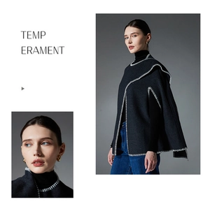 Detail of premium black wool cape coat featuring white decorative whipstitch edges