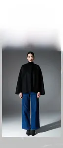 Classic black double-sided wool sleeveless cape poncho styled with blue denim jeans