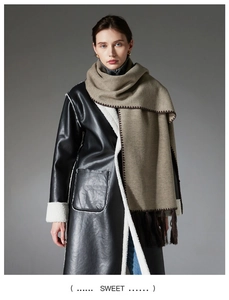 Close-up of khaki double-sided cashmere scarf with dark brown hand-stitched edges and fringe