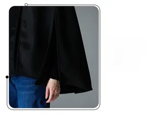 Detailed close-up of high-quality black wool cape coat showing side slit and decorative stitching