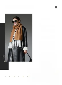 Detail of camel wool scarf with white tassels worn over a black winter leather shearling coat
