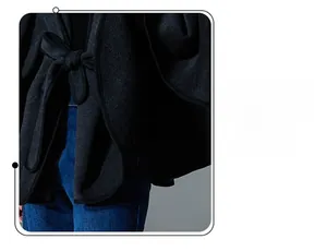 Detail of dark grey wool cape showing high-quality piping edges and adjustable waist belt