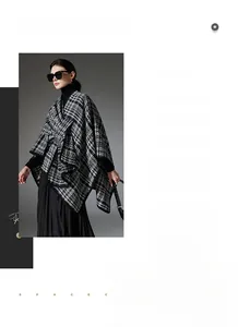 Close-up of black and white plaid knit shawl with textured tweed-style woven fabric