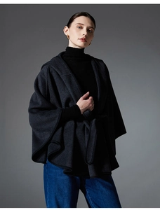 Detail of dark grey hooded cape coat with self-tie waist belt and elegant wool-blend texture
