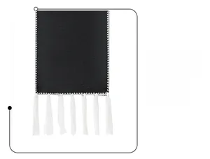 Close-up of black double-sided fabric with white fringe tassels and stitched edge detail