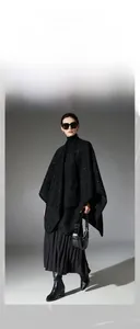 Detailed close-up of a black sequined tweed shawl with elegant shimmering texture and finish