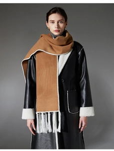 Detail of camel wool scarf with tassel fringe and contrast stitching for winter styling