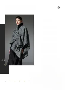 Close-up of thick black and white bouclé wool texture and premium bound edge detailing