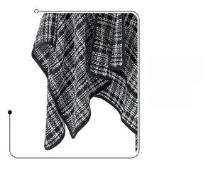 Close-up of black and white plaid tweed fabric texture and fine stitching details