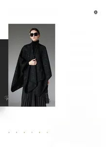 Detail view of a black sequined wool poncho cape featuring classic tweed texture on model