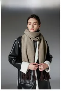 Detail view of coffee-colored winter scarf with contrast stitching and fringed edges