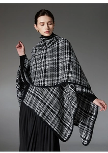 Detail of premium black and white checkered shawl with woven texture and black edging