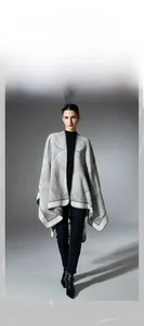 Close-up of geometric knit shawl showing detailed gray and white jacquard pattern