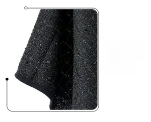 Close-up of black tweed fabric featuring shimmering sequins and premium hemmed edge detail