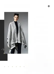 Detail of grey geometric pattern knit shawl wrap with soft wool blend texture