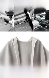 Gros plan d'un poncho à capuche en laine et cachemire gris clair montrant le tissu doux