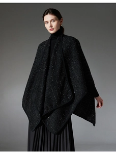 Detail of elegant black tweed shawl with subtle sequins and wool blend texture