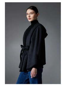 Detail of dark grey hooded cloak with tie waist belt and high-quality wool finish