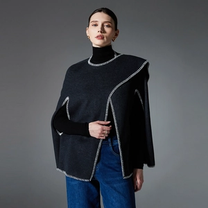 Dark grey wool blend poncho with white blanket stitching detail for autumn winter fashion
