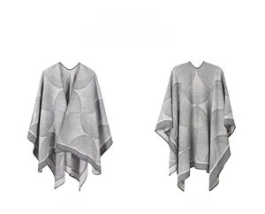 Front and back view of a gray and white geometric wave knit poncho with wool texture