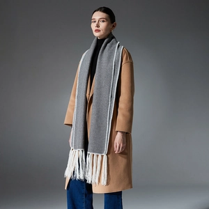 Long dark grey wool blend scarf with white tassel trim and decorative stitching for winter