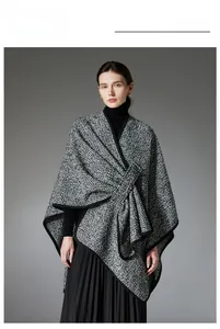 Detailed view of black and white checkered tweed wool shawl with thick black edge binding