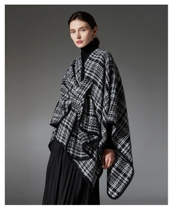 Detailed view of the textured black and white plaid knit shawl with premium edging