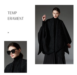 Detail showing the black tweed texture with subtle sequins on a wool shawl cape for women