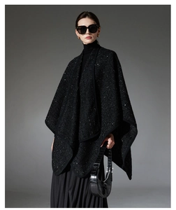 Detailed view of black sequined tweed wool poncho with elegant shimmering texture finish
