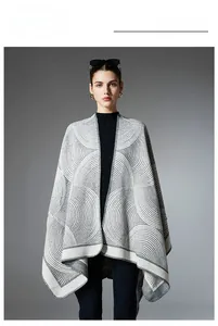 Detail showing grey and white geometric concentric circle patterns on knit shawl wrap
