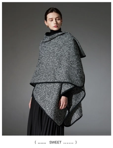 Detail view of black and white tweed wool shawl with premium black piping and thick texture