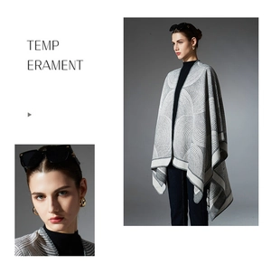 Detailed texture of grey geometric jacquard knit shawl with elegant tassel fringe edge
