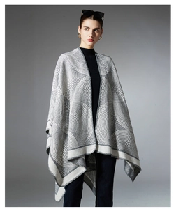 Detailed macro view of the jacquard geometric pattern on gray knitted wool shawl