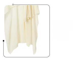 Detailed close-up showing fine knit texture and neat edge of the cream-colored shawl