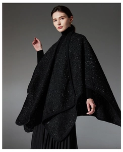 Detailed view of women's black wool shawl with elegant sequins and tweed texture