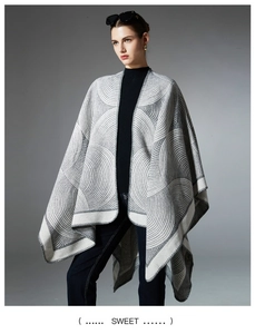 Detail of grey and white geometric jacquard patterns on women's knit shawl poncho