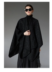Close-up of black tweed wool shawl with shimmering sequins and elegant braided texture