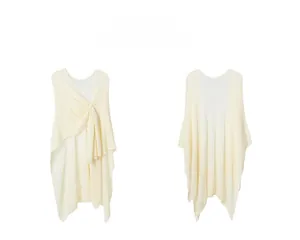 Front and back view of a soft off-white knitted shawl with elegant twist knot detail