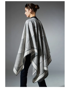 Detail of gray and white geometric wave knit pattern on thick wool blend shawl wrap