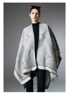 Detail of grey and white geometric jacquard pattern on a soft wool blend shawl