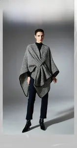 Detail of wool shawl with black and white houndstooth pattern and premium knit texture