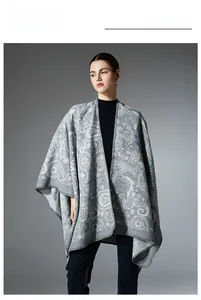 Detail of grey paisley wool shawl showing intricate patterns and premium knit texture
