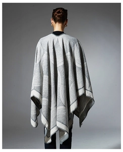 Detailed back view of a geometric jacquard knit shawl with spiral texture and overlock edges