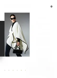 Detail of white knit shawl with black piping and high-contrast designer textures